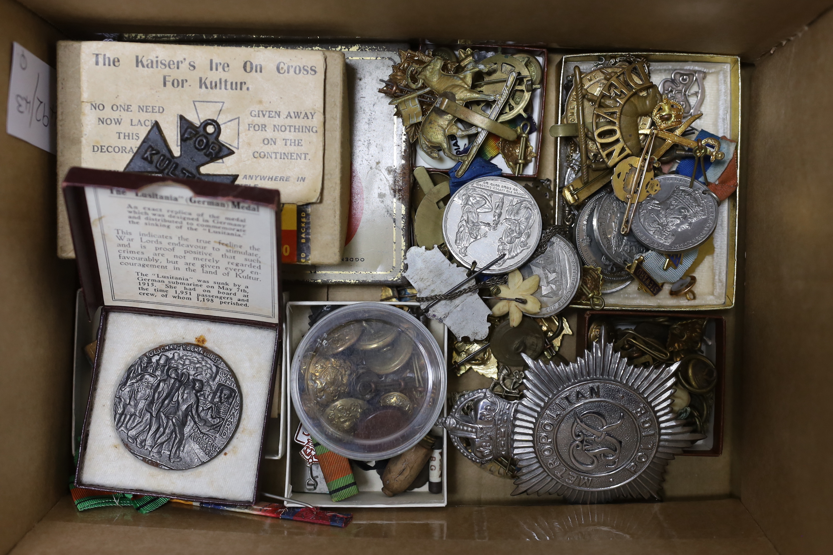 A 15ct. and enamel Tank Corps brooch, a quantity of military cap badges, and buttons, Lusitania medal, other medals, etc.